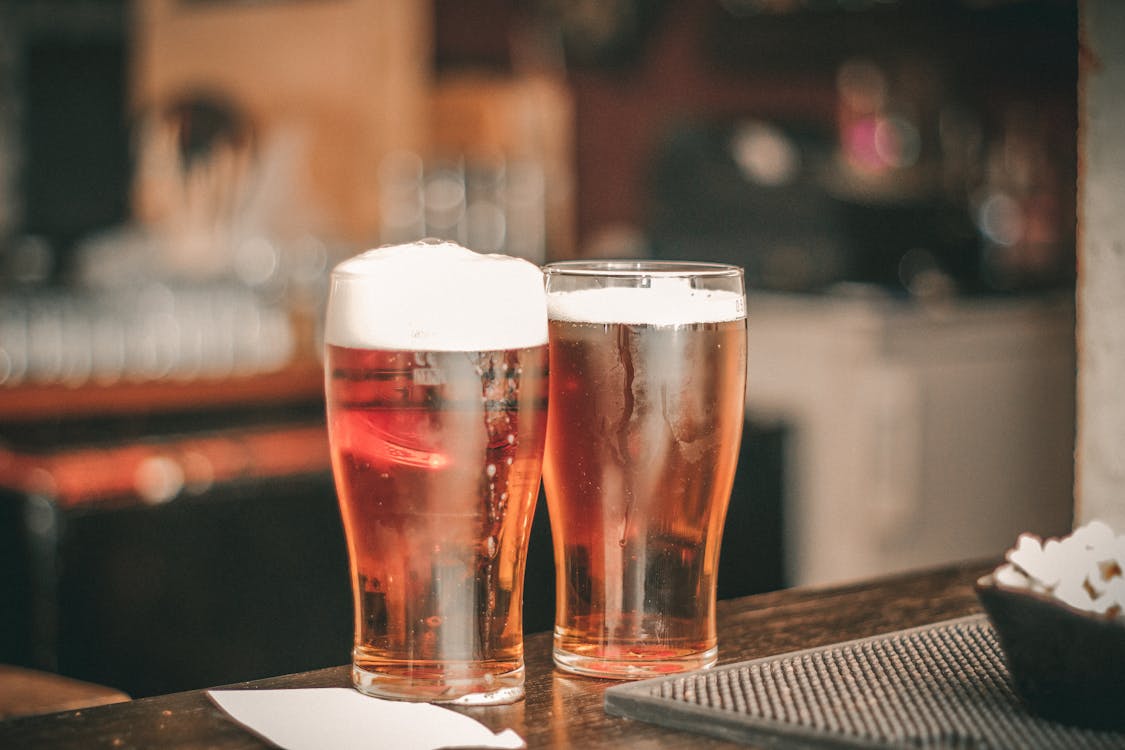 Depth of Field Photo of Two Pilsner Glasses