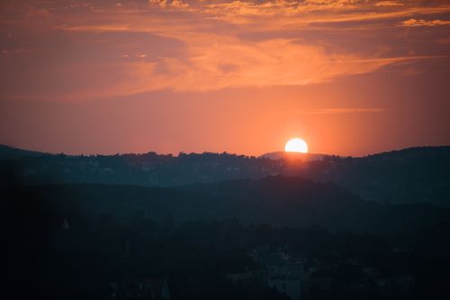 Free Stunning sunset over Budapest's hills, capturing the warm hues and silhouettes of the landscape. Stock Photo