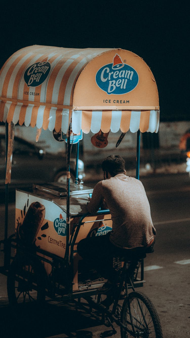 Anonymous Vendor On Street Cart In Night City