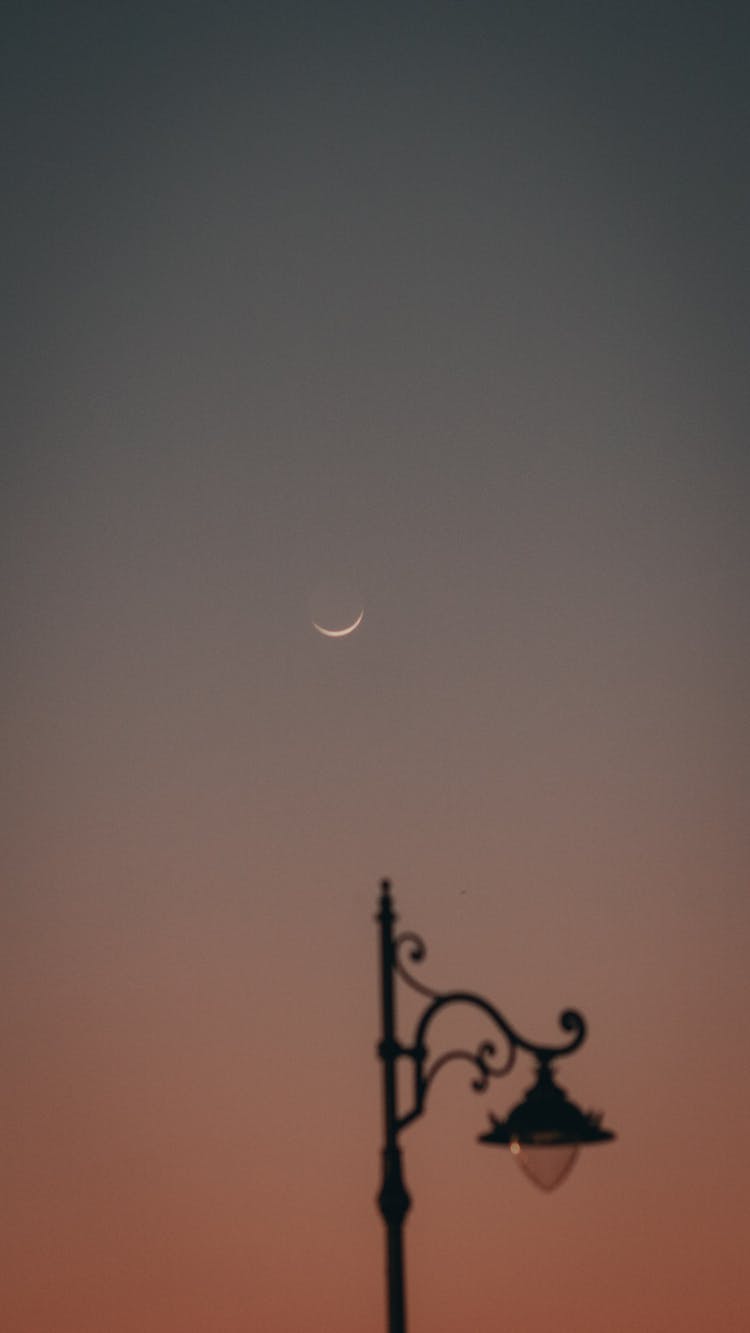 Decorative Lantern Under Moon In Sky At Sunset