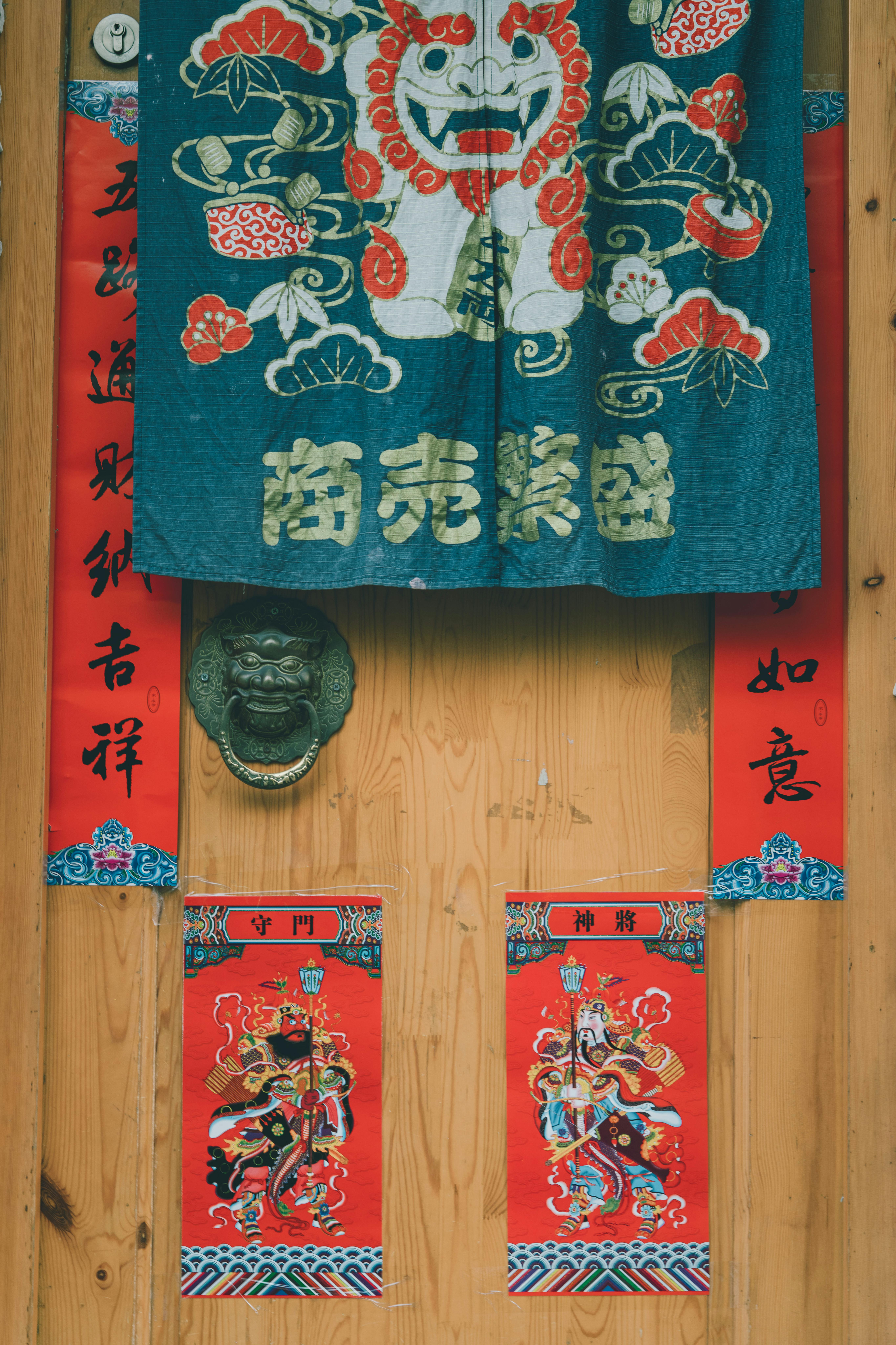 Close-up of a decorated Chinese door with festive textiles and vibrant colors.