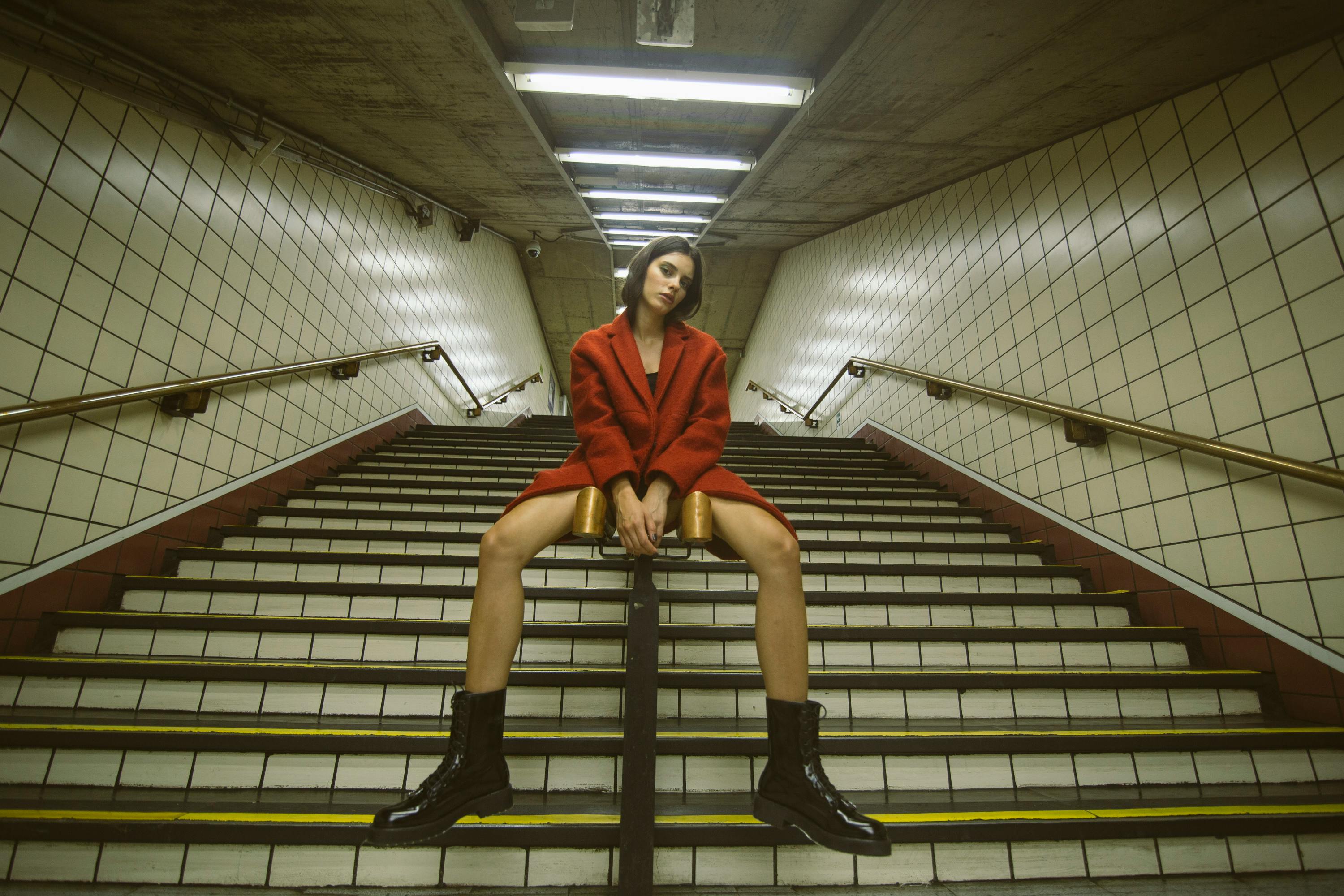 Woman Sitting on Handrail With Both Hand on Front Woman Sitting on Handrail With Both Hand on Front
