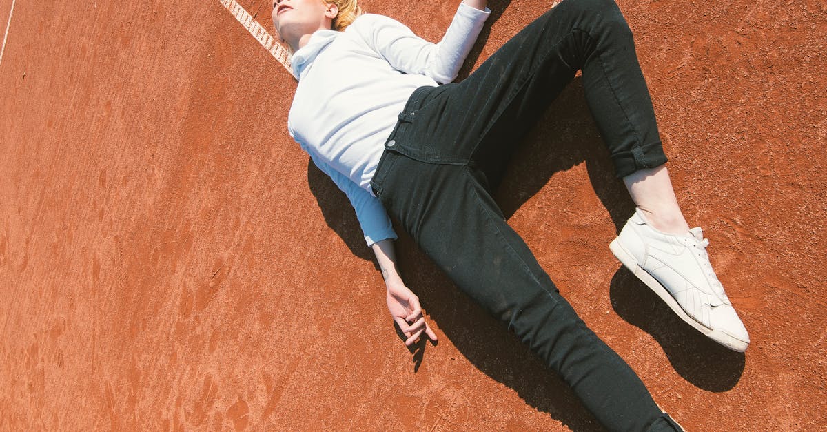 Woman Lying Down on a Brown Concrete Surface
