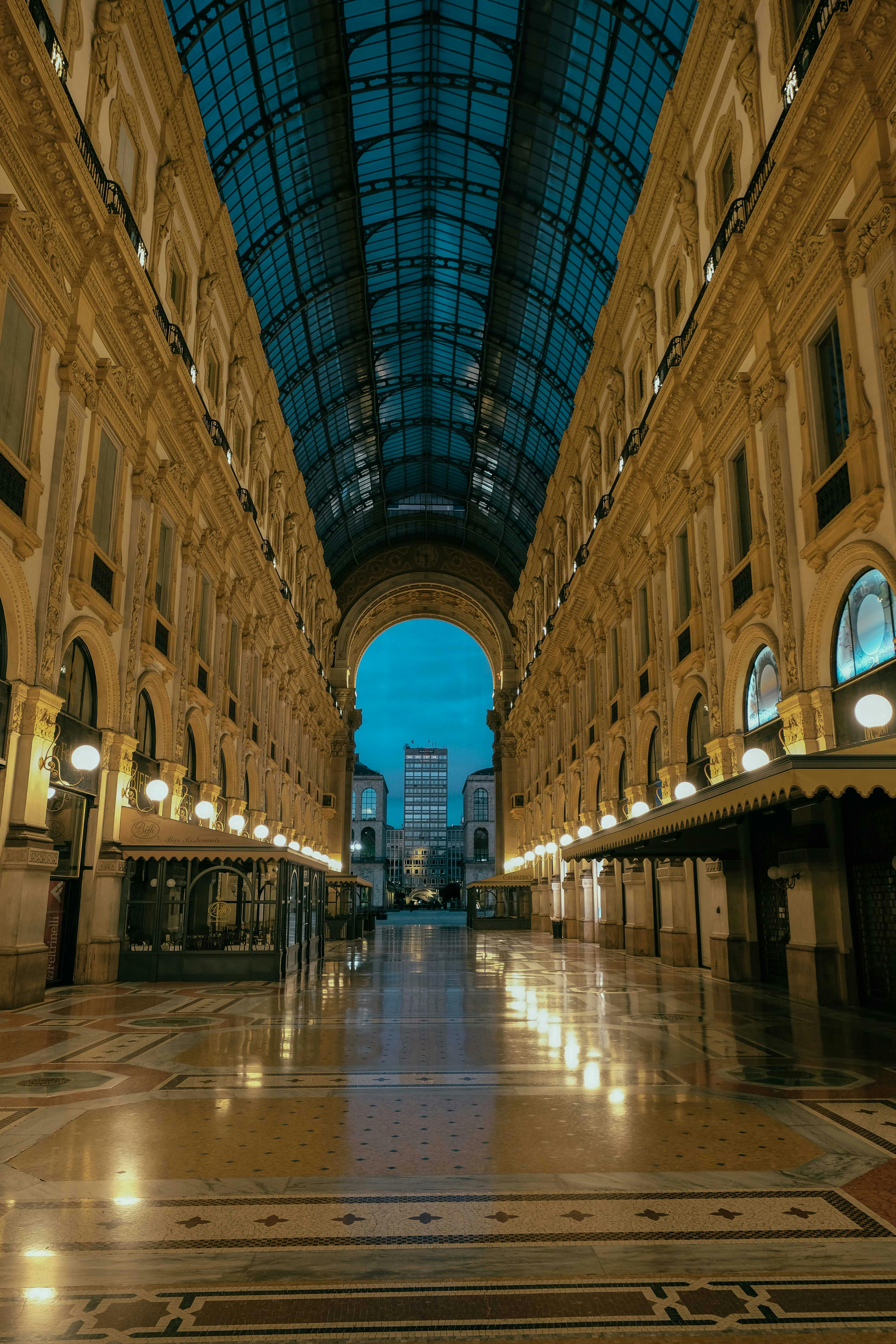 arched passage of shopping gallery with glowing lamps