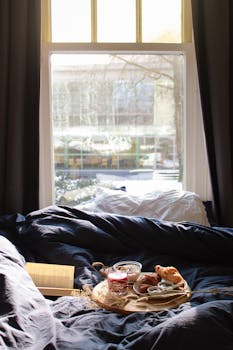 Relaxing morning scene with croissants on a tray by a window, perfect for a cozy lifestyle.