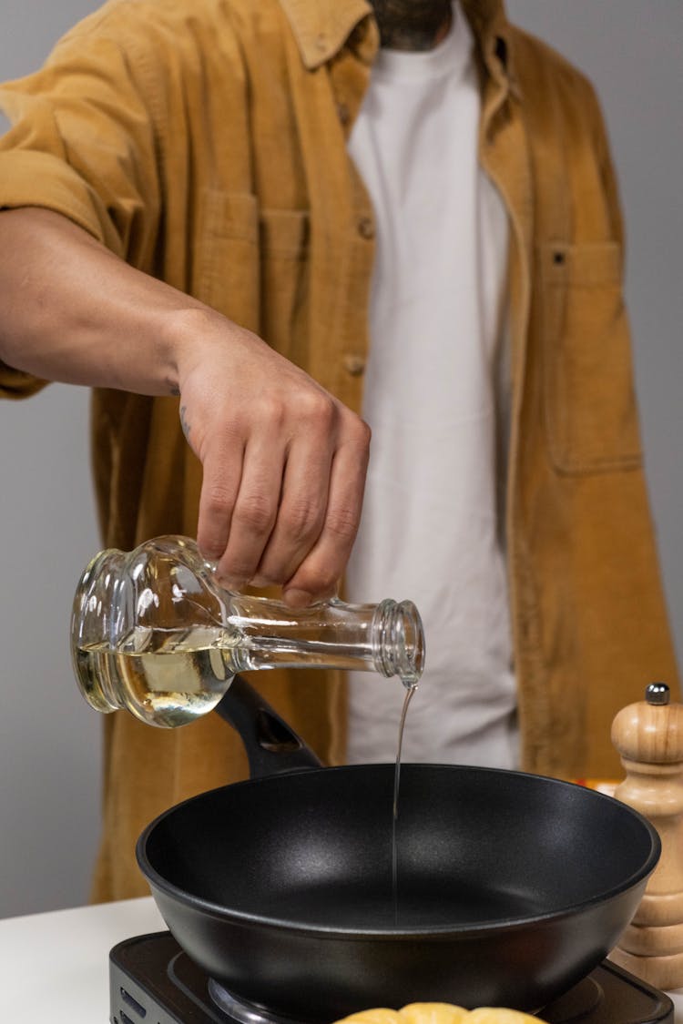 Man Pours Oil To Frying Pan