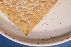Top view of traditional traditional Javanese tempeh placed in ceramic bowl on table in kitchen