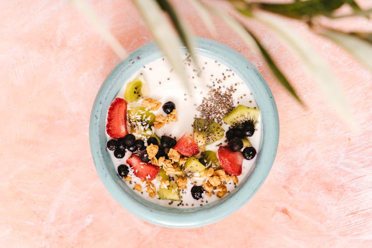 A Bowl Of Cereal With Fruits Topping