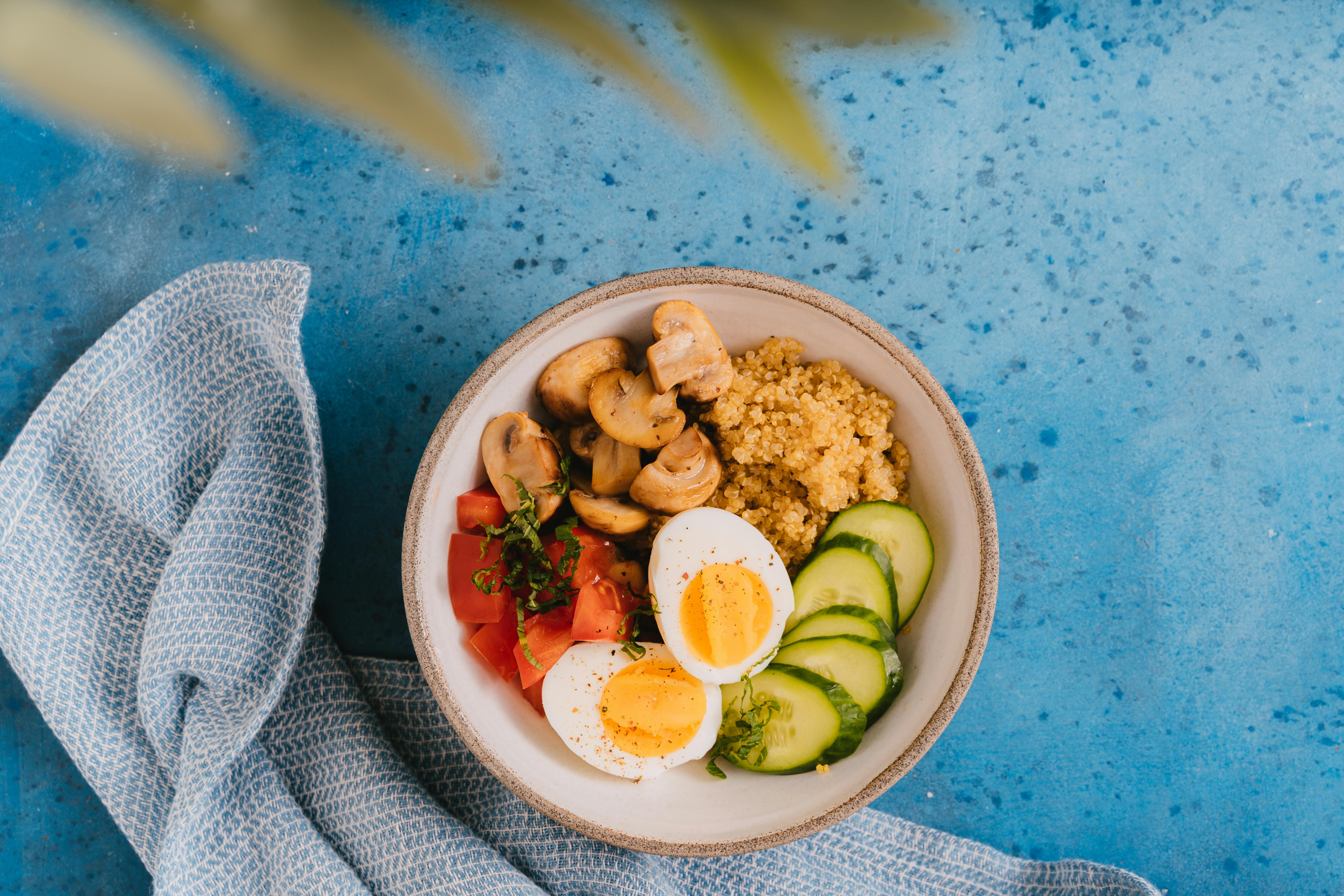 a bowl of food over blue surface