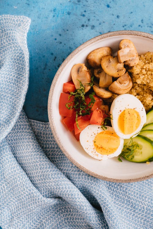 A Bowl of Dish with Vegetable and Boiled Eggs