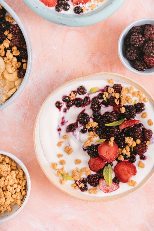 Free Top view of a tasty yogurt bowl with fresh berries and crunchy granola, perfect for a healthy breakfast. Stock Photo