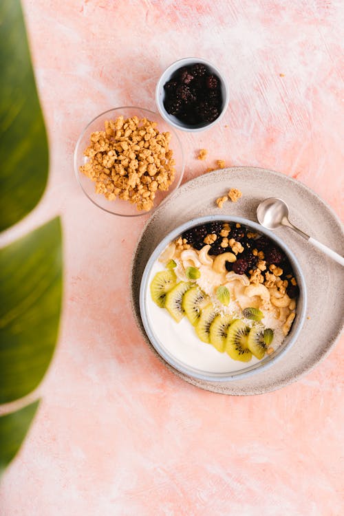 Sliced Kiwi and Blackberries on a Ceramic Bowl