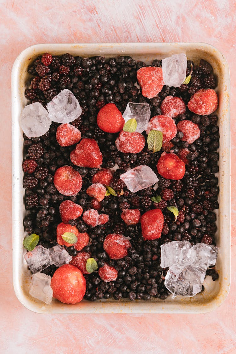 A Tray With Frozen Berries And Ice 