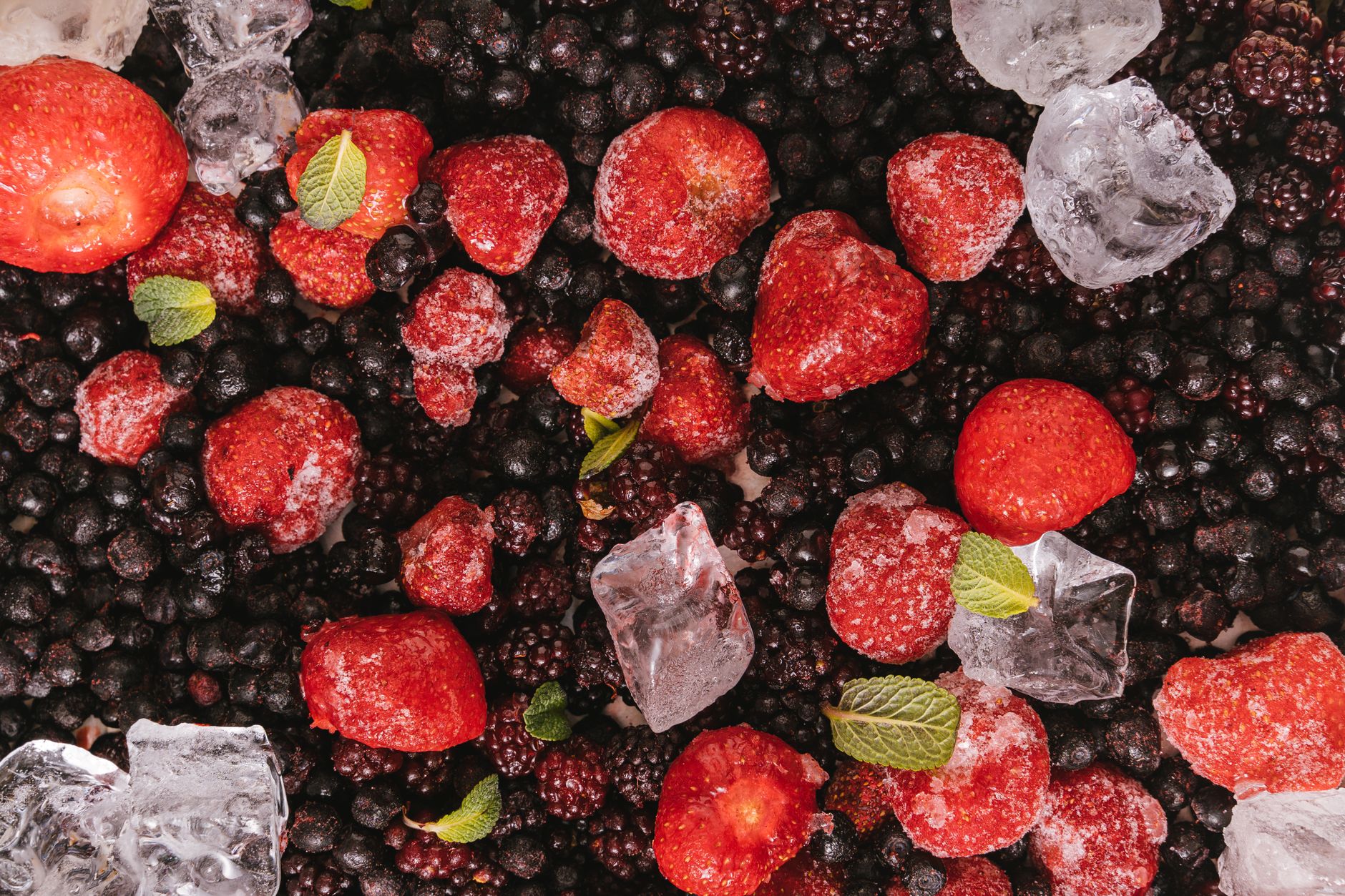 Frozen raspberries being thawed in a bowl