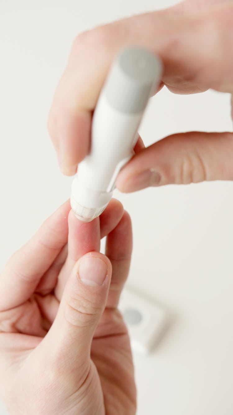 Person Using A Lancet Pen