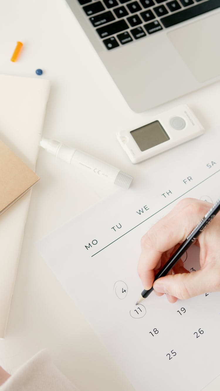 Person Marking And Scheduling Important Dates On Calendar