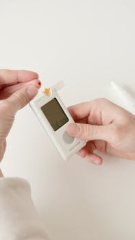 Person checking blood sugar with a glucometer.