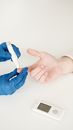 Person in Blue Gloves Holding White Tube