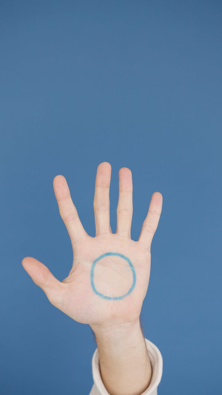 A Hand With Blue Circle Drawing