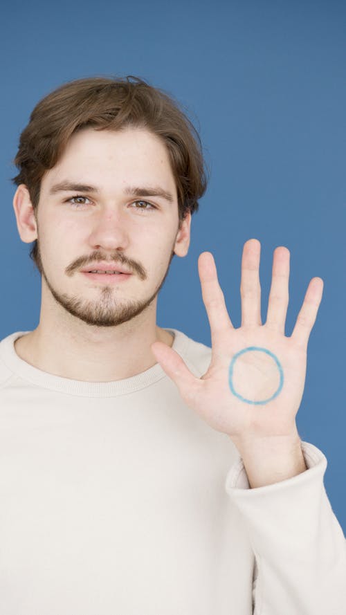 Symbol of Diabetes Painted on the Palm of a Young Man in Support of Diabetic People