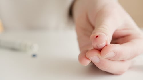 Free Person With Tiny Blood On Finger After A Blood Test Stock Photo