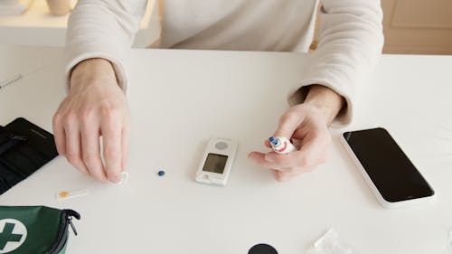 Person in White Long Sleeve Shirt Holding Silver Iphone 6