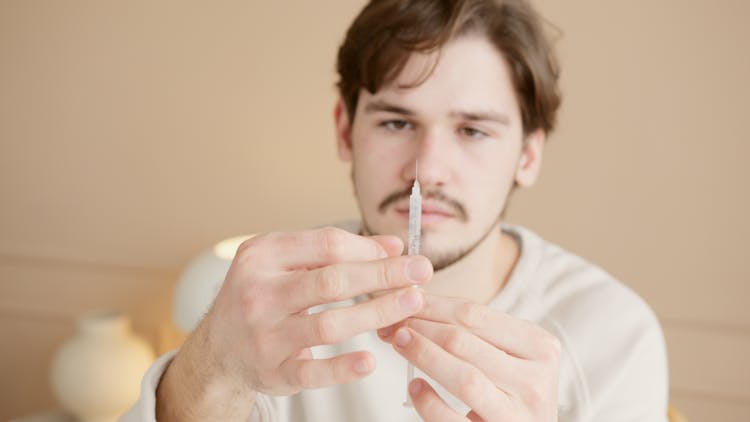 A Man Holding A Syringe