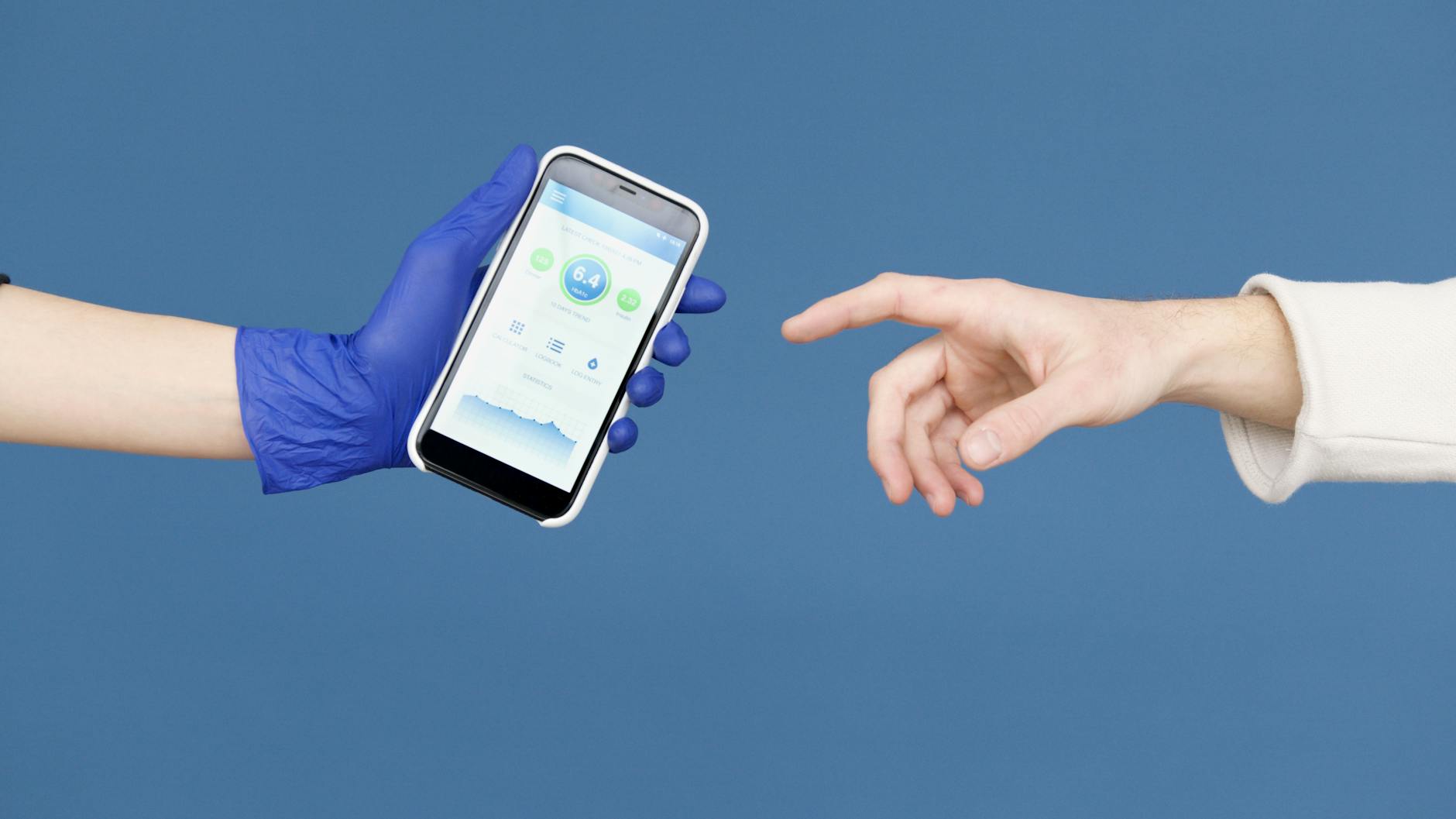 Person wearing Latex Gloves holding Smartphone