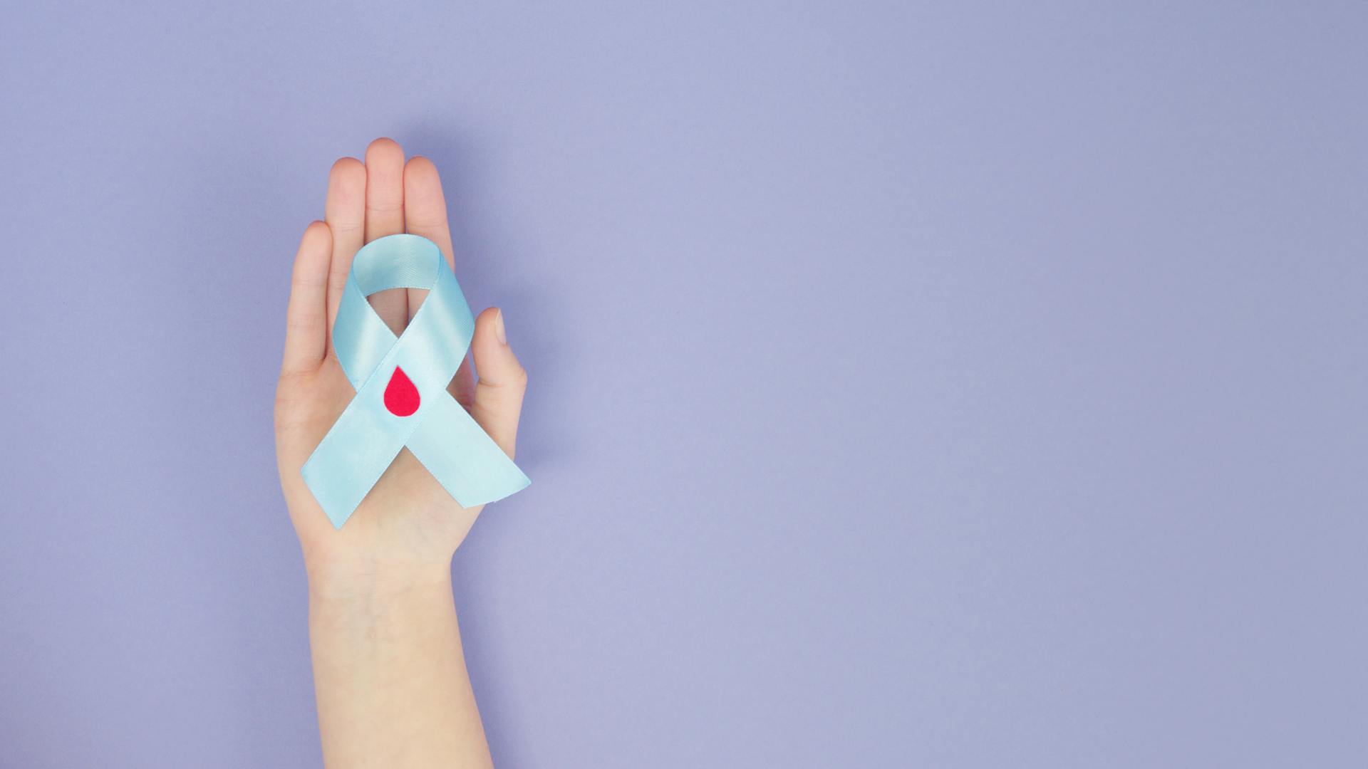 Person Holding A Blue Diabetes Awareness Ribbon With Decorated Blood Drop