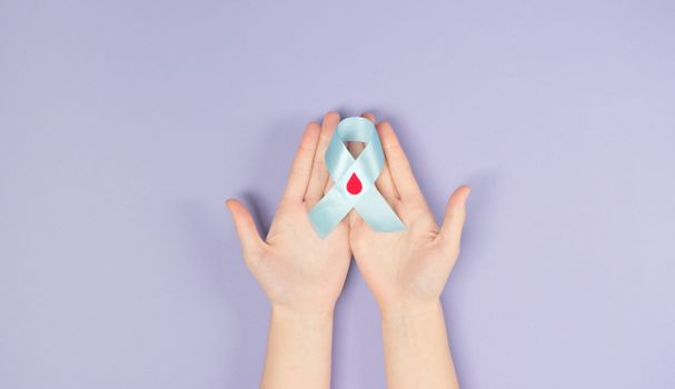 Persons Hand With White and Red Heart Shape
