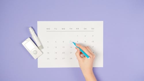 Free Person Drawing a Circle on a Calendar  Stock Photo