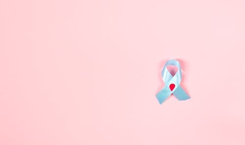 Free Blue Diabetes Awareness Ribbon With Decorated Blood Drop on Pink Background Stock Photo