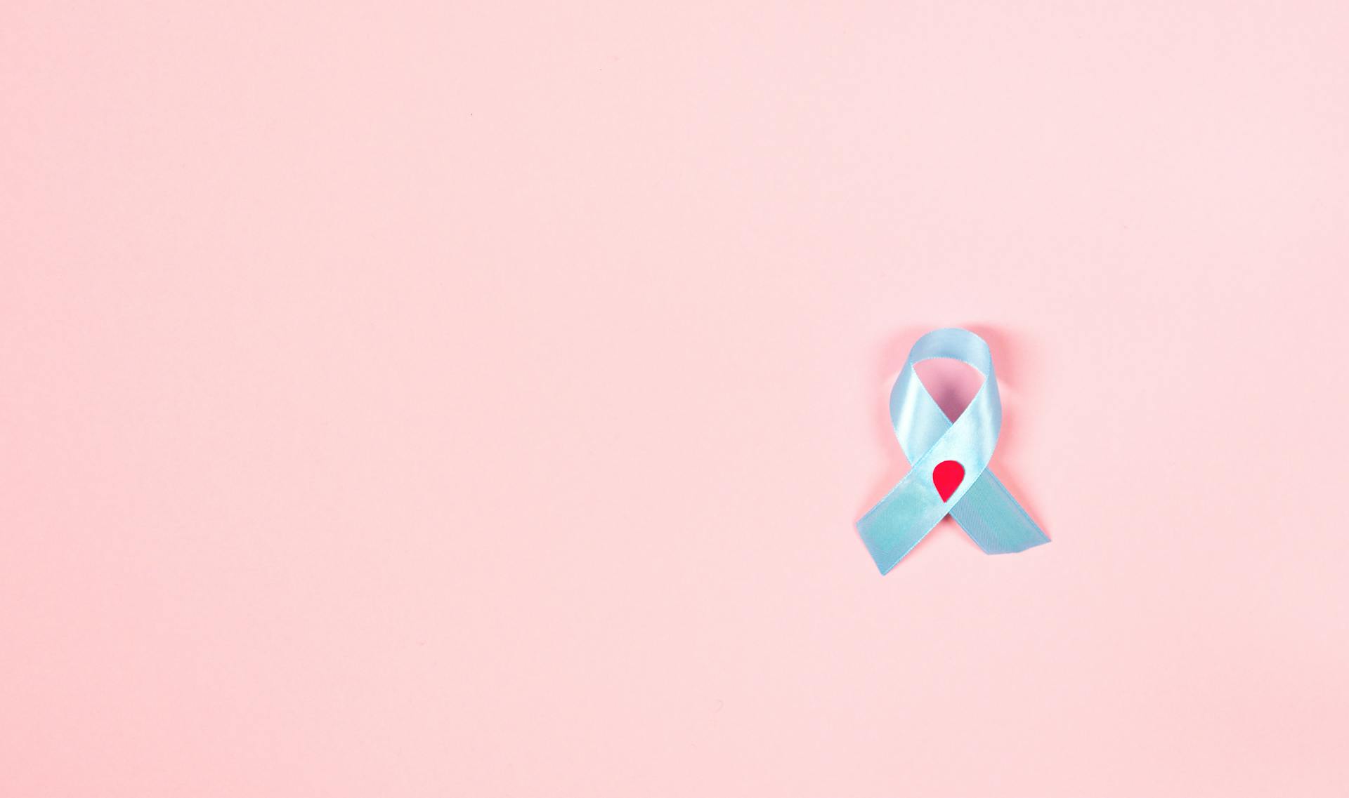 Blue Diabetes Awareness Ribbon With Decorated Blood Drop on Pink Background