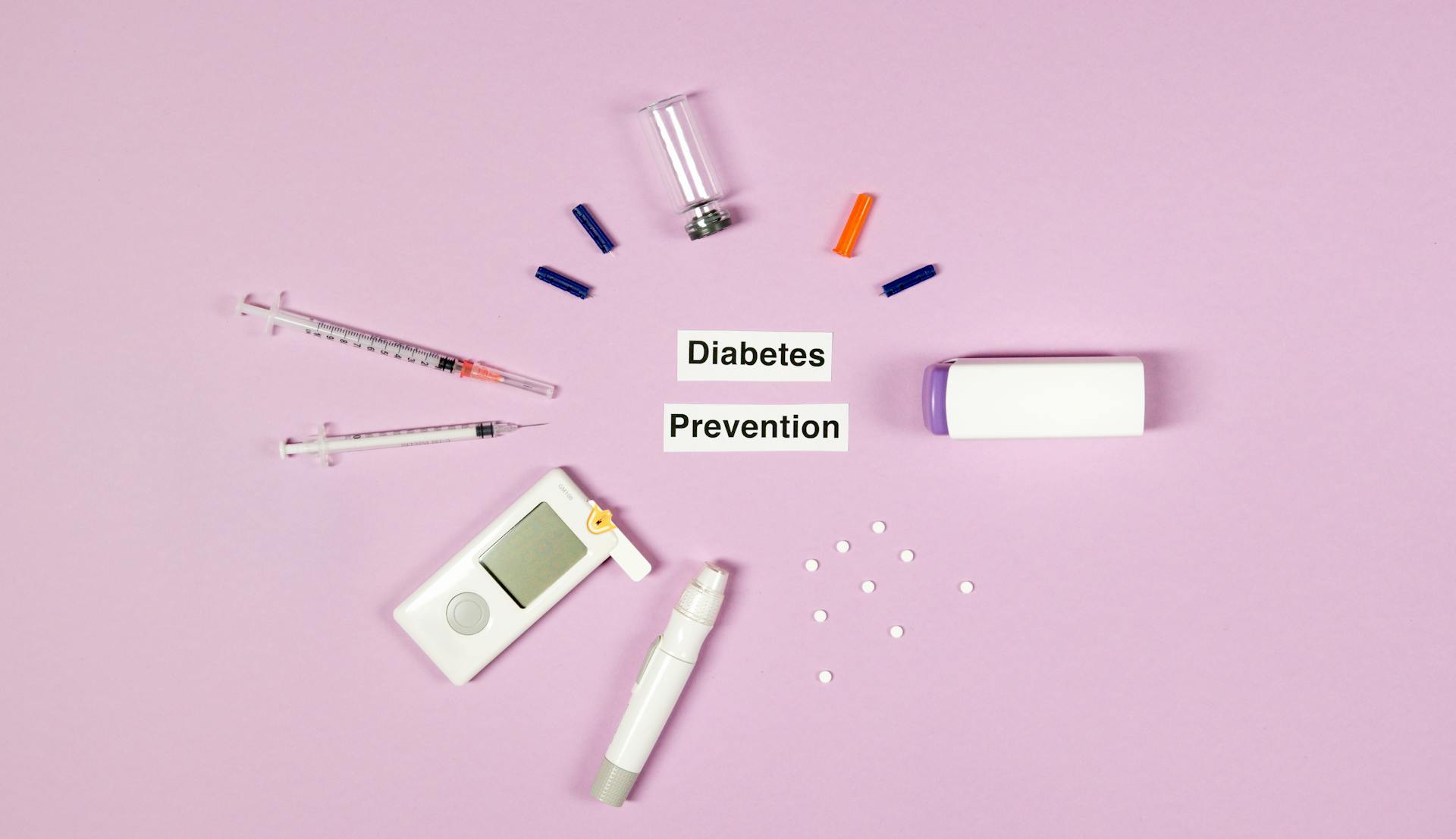 Diabetes Prevention Text On Pink Background With Medical Supplies