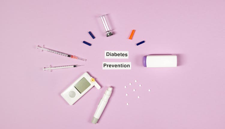 Diabetes Prevention Text On Pink Background With Medical Supplies