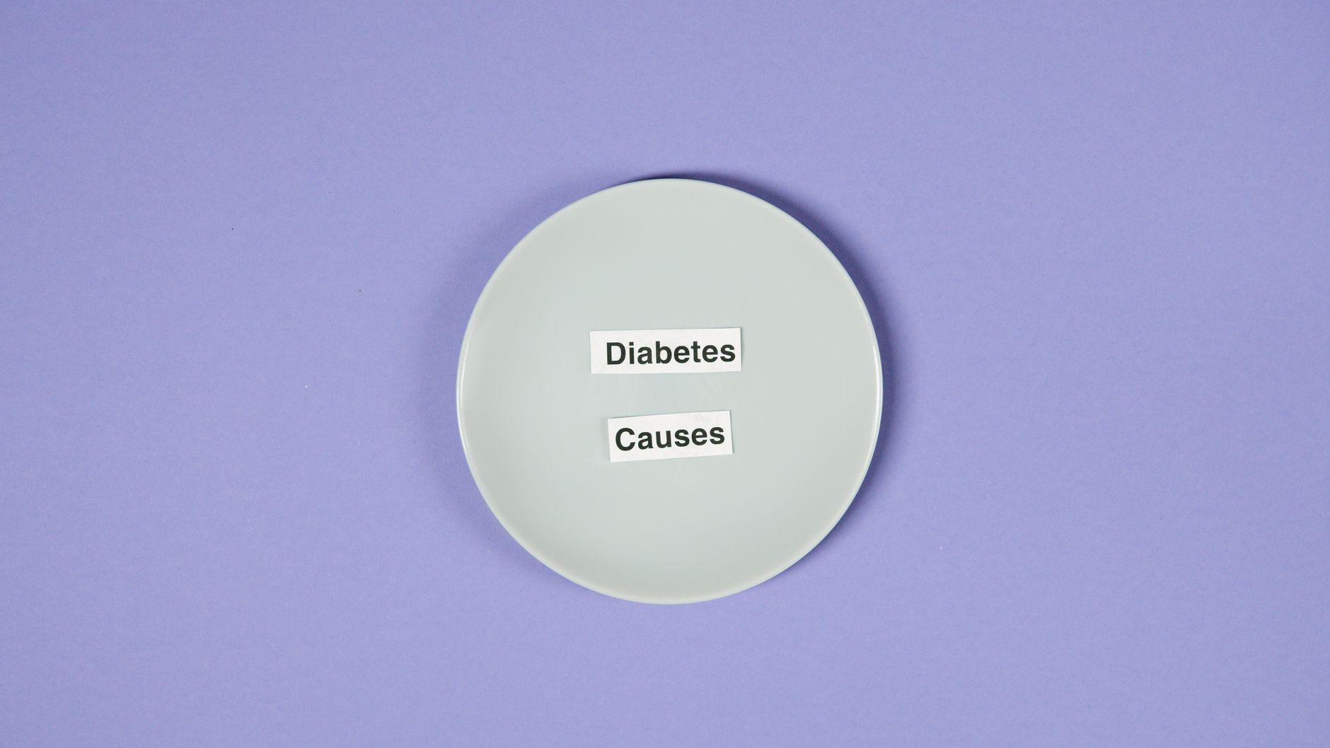 A conceptual photo of a white plate with diabetes causes text on a purple background.