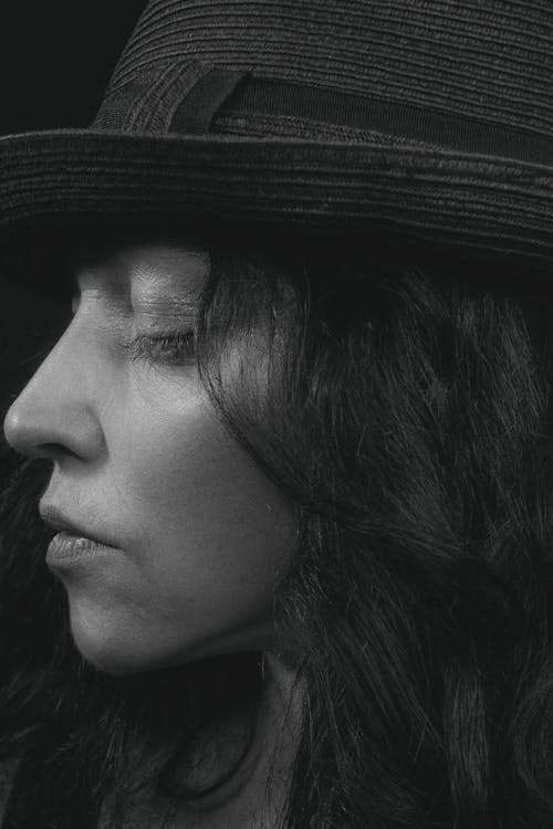 Grayscale Photo of Woman Wearing Hat