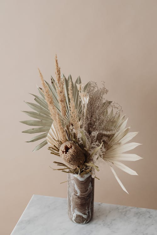 Free A Vase Full of Dry Leaves and Grass Flowers Stock Photo
