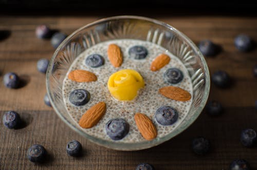 A Chia Seeds on a Glass Bowl with Almonds and Blueberries