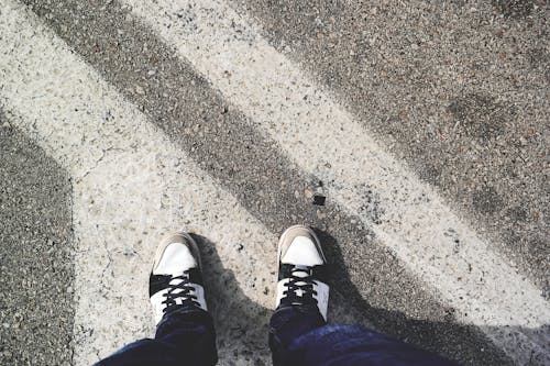 Free Man in White and Black Sneakers Standing Outdoor during Daytime Stock Photo