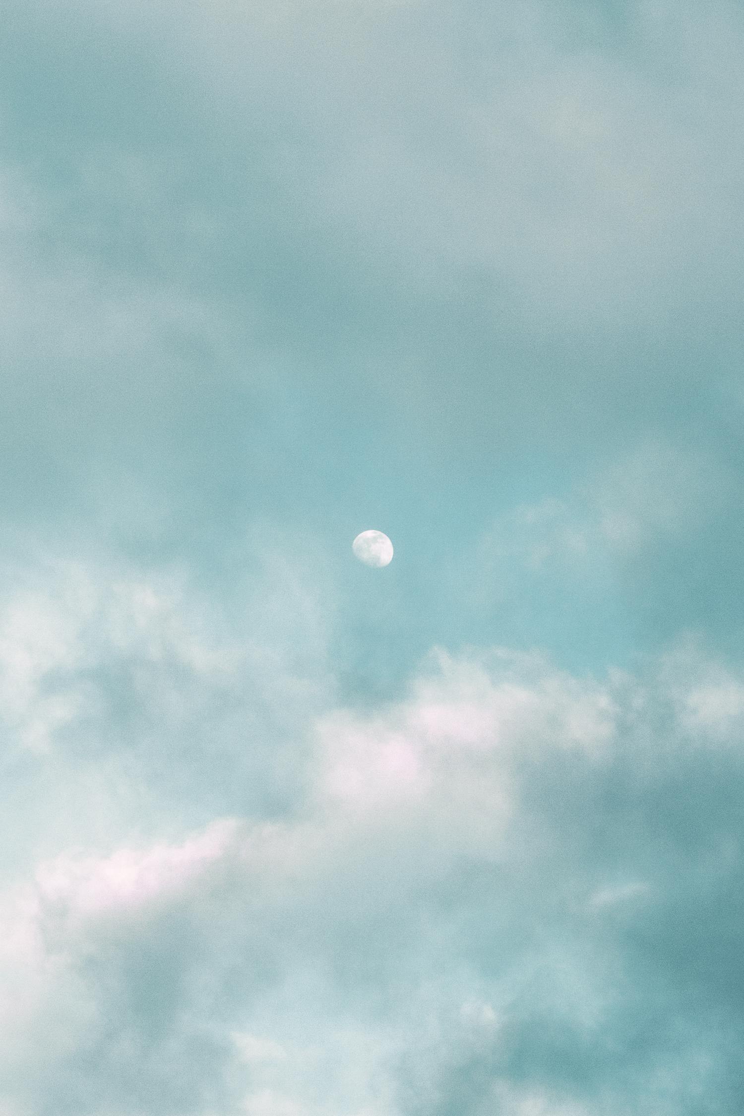 Light moon in blue sky with clouds · Free Stock Photo