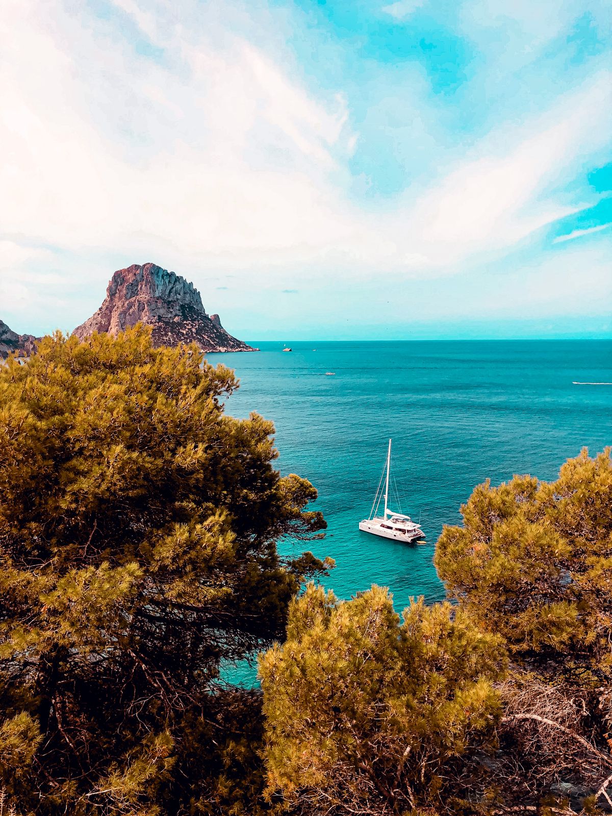 A yacht on the sea shore in Ibiza — chartering by yacht is the most beautiful way to see the island