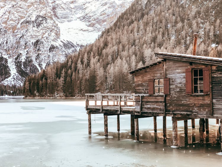 House On Stilts In A Frozen Mountain Lake 