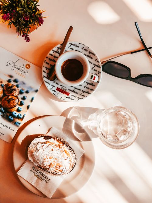 Free Enjoy a cozy breakfast with espresso, pastry, and a magazine, perfect start to the day. Stock Photo