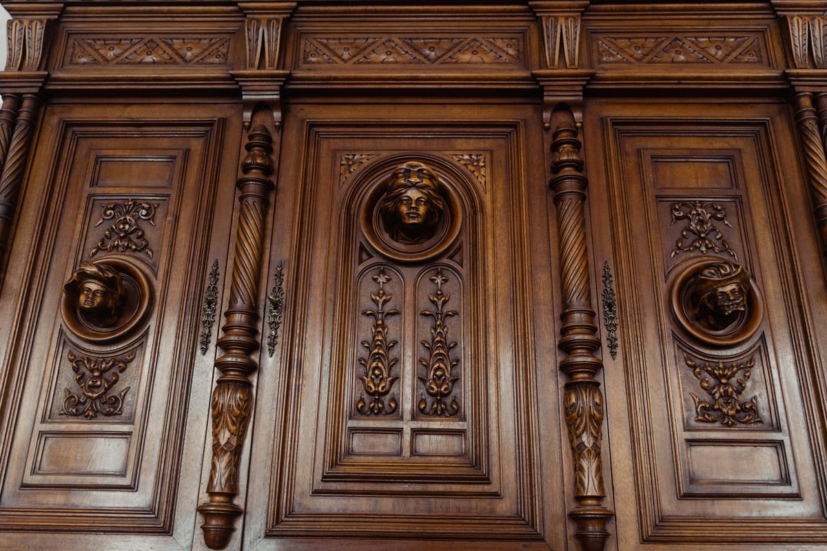 Detail of an antique carved wood panel with a central cartouche