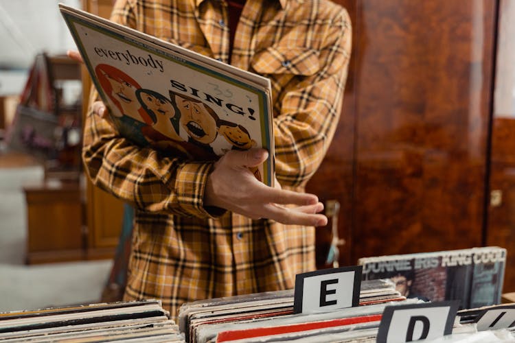 A Person Holding A Vinyl Music Record