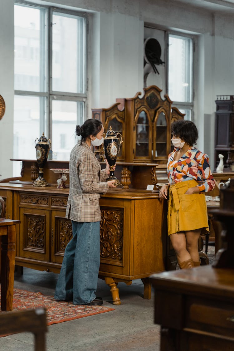 Women Wearing Facemasks Inside An Antique Shop