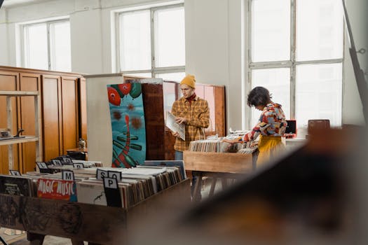 Two people browse vinyl records in a cozy, vintage-themed record shop.
