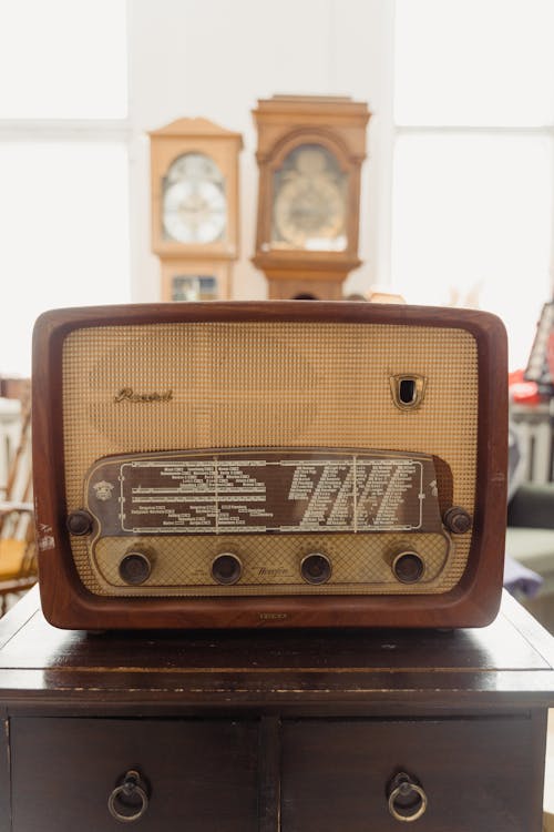 A Vintage Radio on Top of a Wooden Drawers