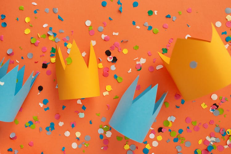 Crowns And Confetti On Orange Background